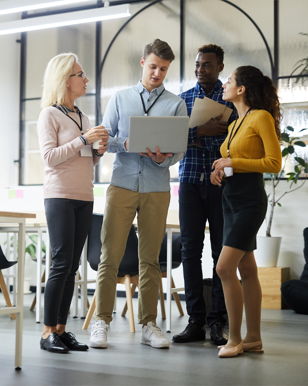 Team in quick discussion at an ad agency.